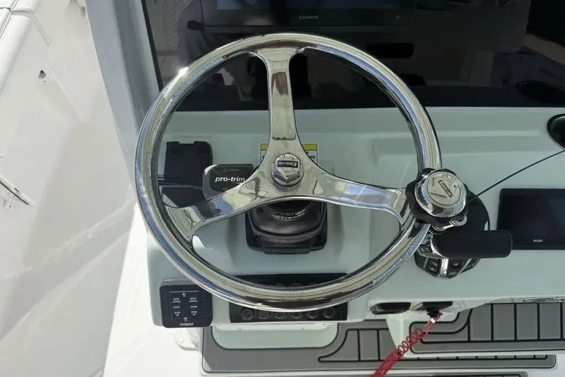 Slide: The Image of Steering wheel of 2026 Tidewater 2500 Carolina Bay boat, featuring modern controls. - 27