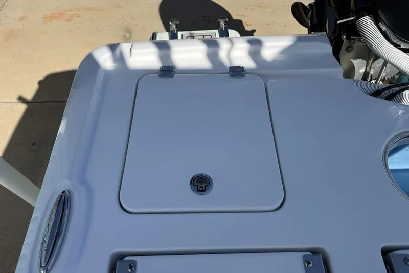 Slide: The Image of 2026 Tidewater 2500 Carolina Bay boat deck with hatch and engine components. - 33