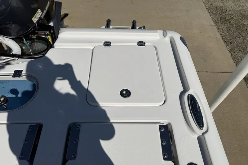 Slide: The Image of 2026 Tidewater 2500 Carolina Bay boat deck with storage compartments and engine components. - 42