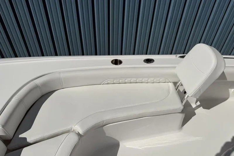 Slide: The Image of 2026 Tidewater 2500 Carolina Bay boat interior with white cushioned seating. - 8