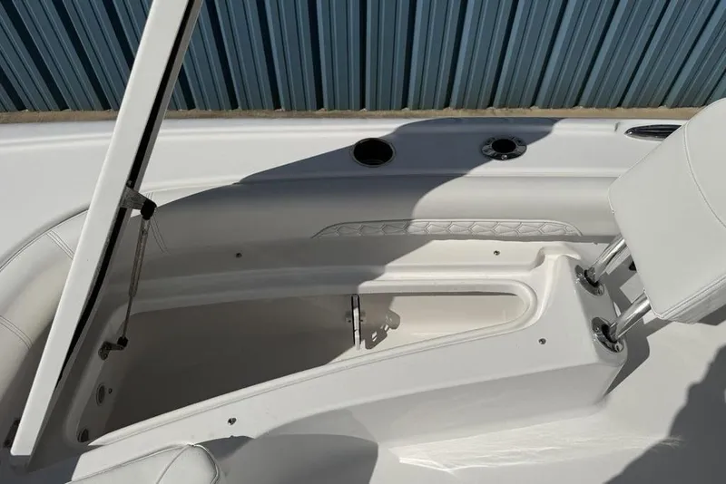Slide: The Image of 2026 Tidewater 2500 Carolina Bay boat interior with open storage compartment. - 9