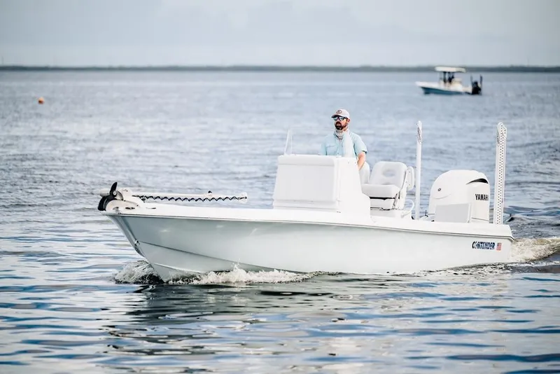 Slide: The Image of 2026 Contender 26 Bay boat cruising on open water with a Yamaha engine. - 9
