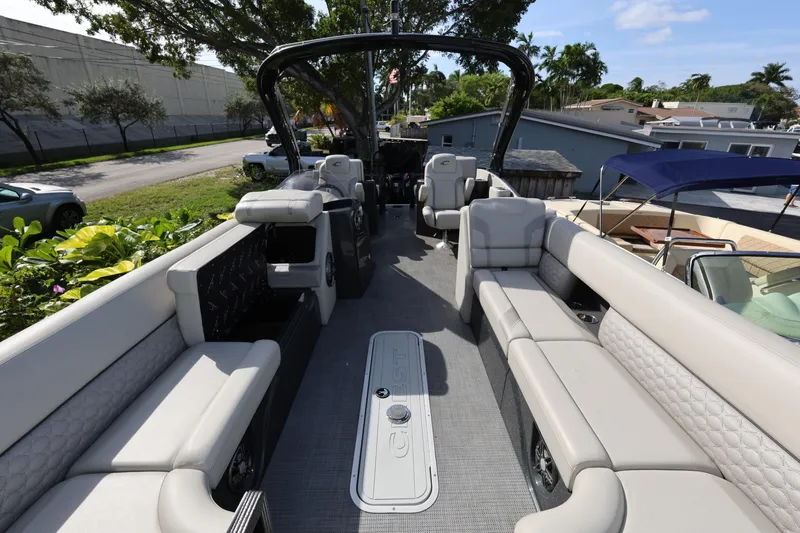 Slide: The Image of 2022 Crest Caribbean Platinum 250SLRC pontoon boat with luxurious seating and modern design. - 12