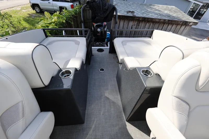 Slide: The Image of 2022 Crest Caribbean Platinum 250SLRC boat interior with plush seating and cup holders. - 16