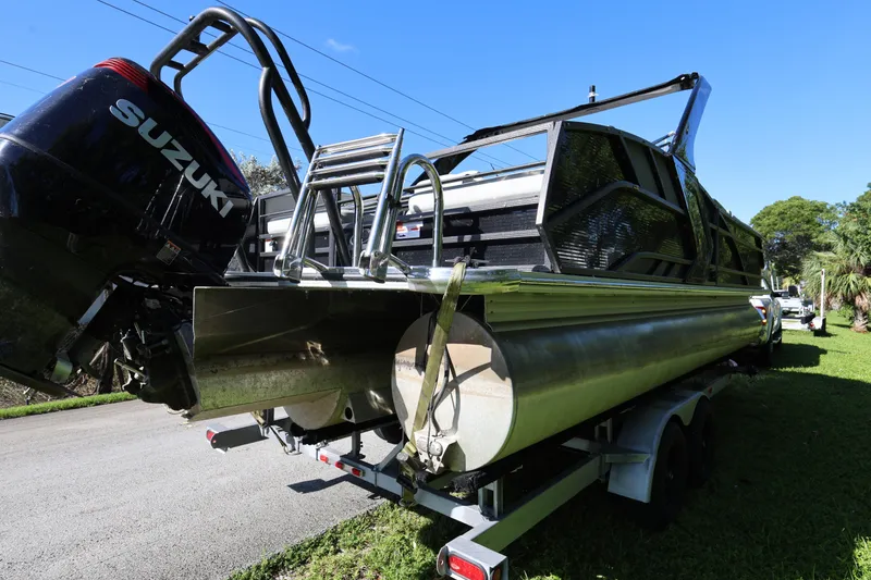 Slide: The Image of 2022 Crest Caribbean Platinum 250SLRC pontoon boat with Suzuki outboard motor on trailer. - 4