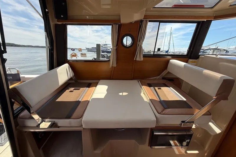 Slide: The Image of Interior of 2017 Ranger Tugs R-23 boat with seating and window view of marina. - 20