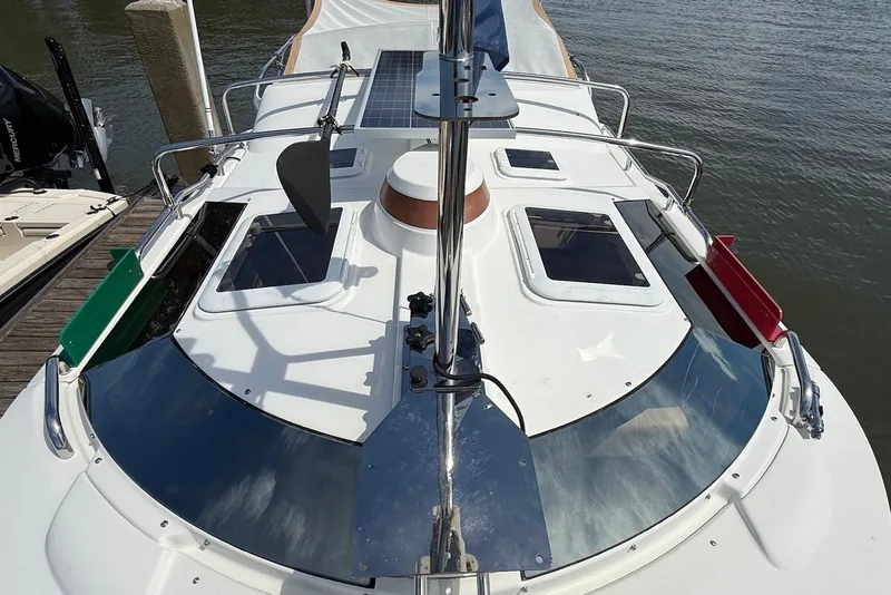 Slide: The Image of 2017 Ranger Tugs R-23 boat deck with solar panel and hatches, docked by the water. - 4