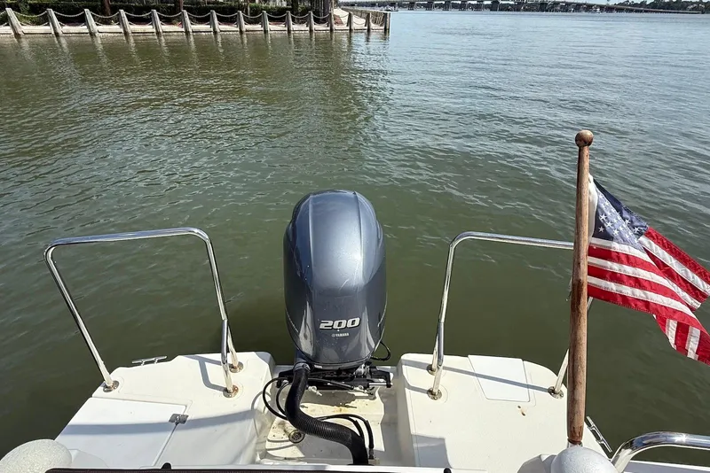 Slide: The Image of 2017 Ranger Tugs R-23 boat with Yamaha 200 engine and American flag on water. - 7