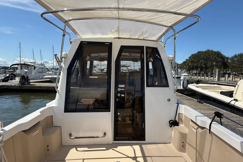 Slide: The Image of 2017 Ranger Tugs R-23 boat docked at marina, rear view with canopy. - 8