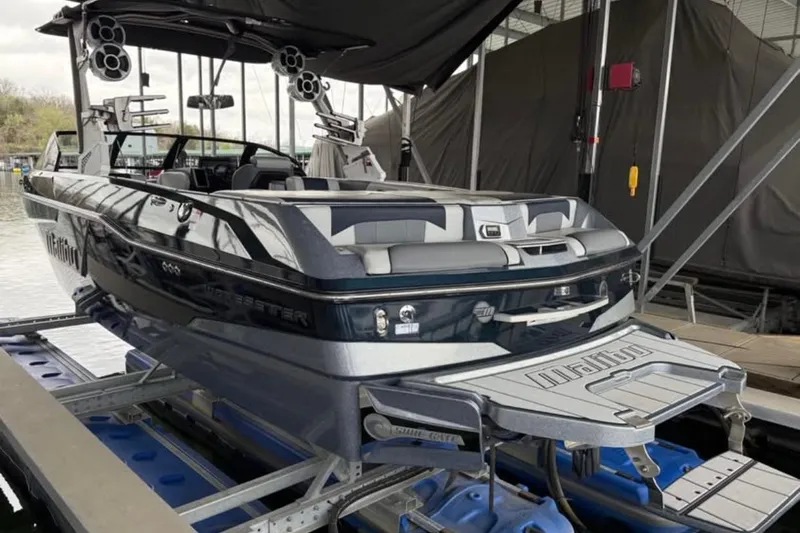 Slide: The Image of 2021 Malibu Wakesetter 25 LSV boat on lift, docked in marina. - 13