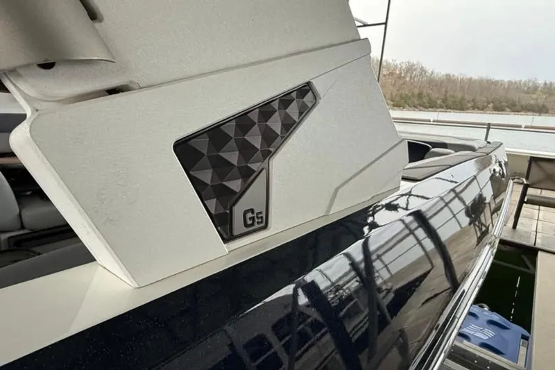Slide: The Image of 2021 Malibu Wakesetter 25 LSV boat detail with geometric design and "Gs" emblem. - 19