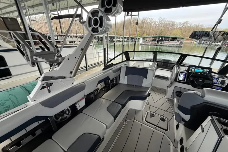 Slide: The Image of 2021 Malibu Wakesetter 25 LSV interior with sleek seating and advanced dashboard controls. - 24