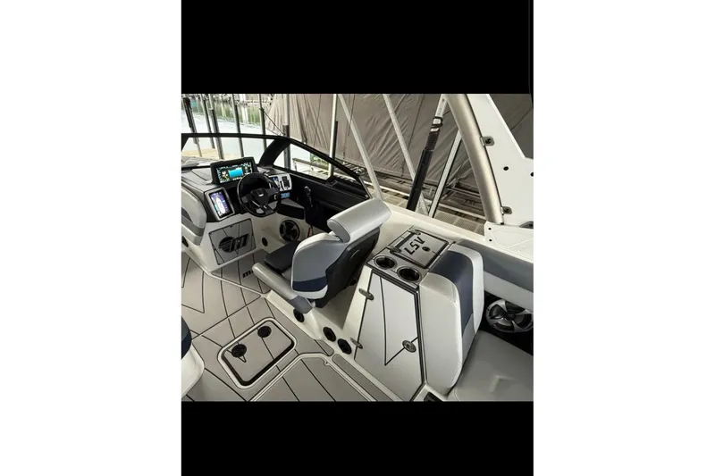 Slide: The Image of 2021 Malibu Wakesetter 25 LSV boat interior with modern dashboard and seating. - 25