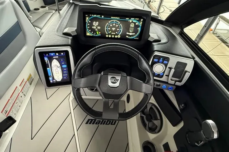 Slide: The Image of 2021 Malibu Wakesetter 25 LSV dashboard with advanced digital controls and steering wheel. - 26