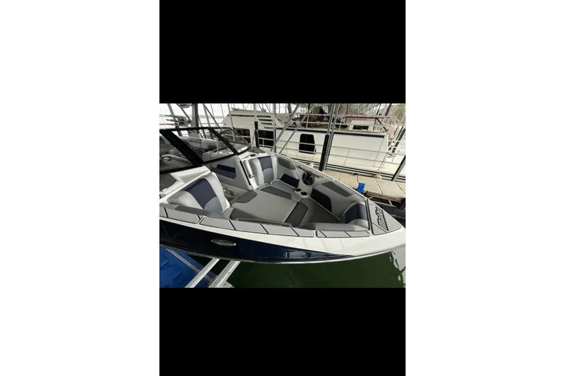 Slide: The Image of 2021 Malibu Wakesetter 25 LSV boat with sleek interior design, docked in marina. - 29