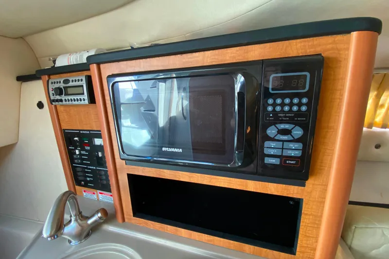Slide: The Image of 2006 Sea Ray 240 Sundancer interior with microwave, control panel, and sink. - 19