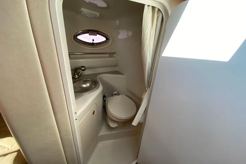 Slide: The Image of Compact bathroom in 2006 Sea Ray 240 Sundancer boat with sink and toilet. - 25
