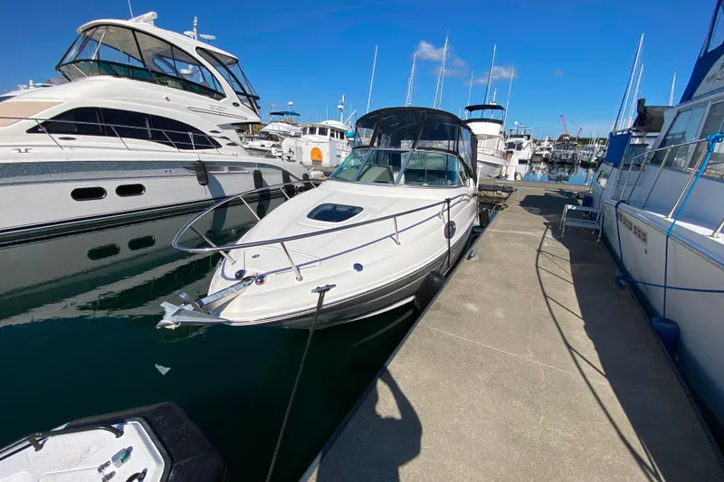 Slide: The Image of 2006 Sea Ray 240 Sundancer docked at marina under clear blue sky. - 32