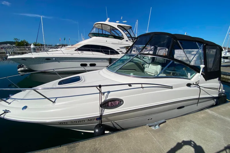 Slide: The Image of 2006 Sea Ray 240 Sundancer docked at marina under clear blue sky. - 33