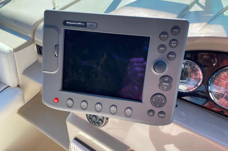 Slide: The Image of Control panel on 2006 Sea Ray 240 Sundancer boat dashboard with navigation display. - 6