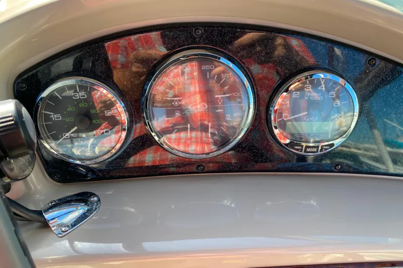 Slide: The Image of Dashboard of a 2006 Sea Ray 240 Sundancer boat with gauges and controls. - 8