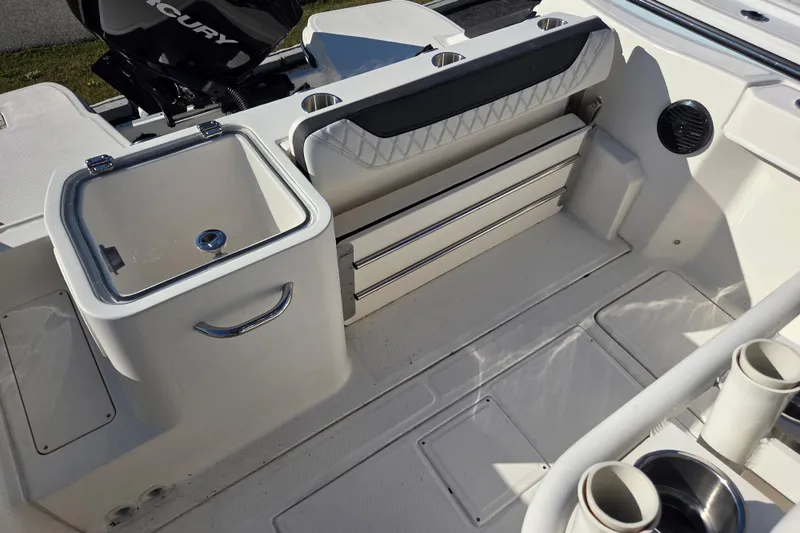 Slide: The Image of 2023 Trophy T24 CC boat interior with storage compartments and seating area. - 11