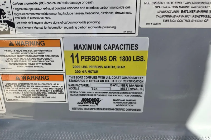 Slide: The Image of 2023 Trophy T24 CC capacity label: 11 persons, 1800 lbs, 300 HP motor, safety warnings. - 14