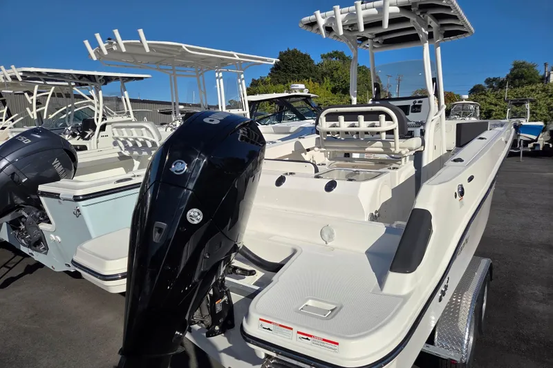 Slide: The Image of 2023 Trophy T24 CC boat with dual outboard engines, parked on a trailer. - 4
