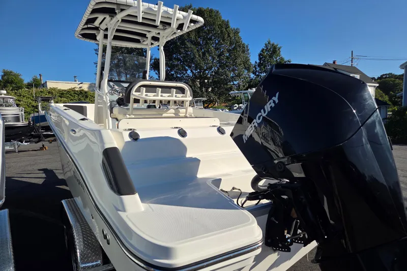 Slide: The Image of 2023 Trophy T24 CC boat with Mercury outboard motor, parked outdoors on a sunny day. - 5
