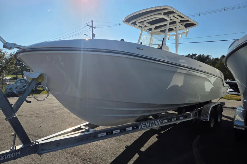 Slide: The Image of 2023 Trophy T24 CC boat on trailer under bright sunlight. - 6