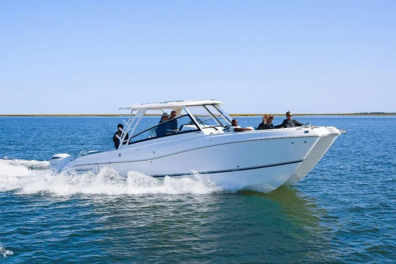 Slide: The Image of 2026 World Cat 325DC cruising on open water with passengers enjoying the ride. - 0
