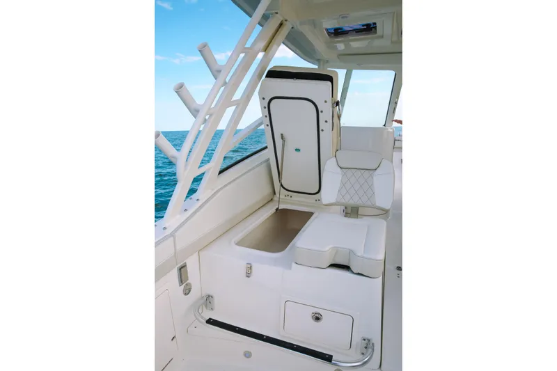 Slide: The Image of 2026 World Cat 325DC boat interior with white seating and ocean view. - 10