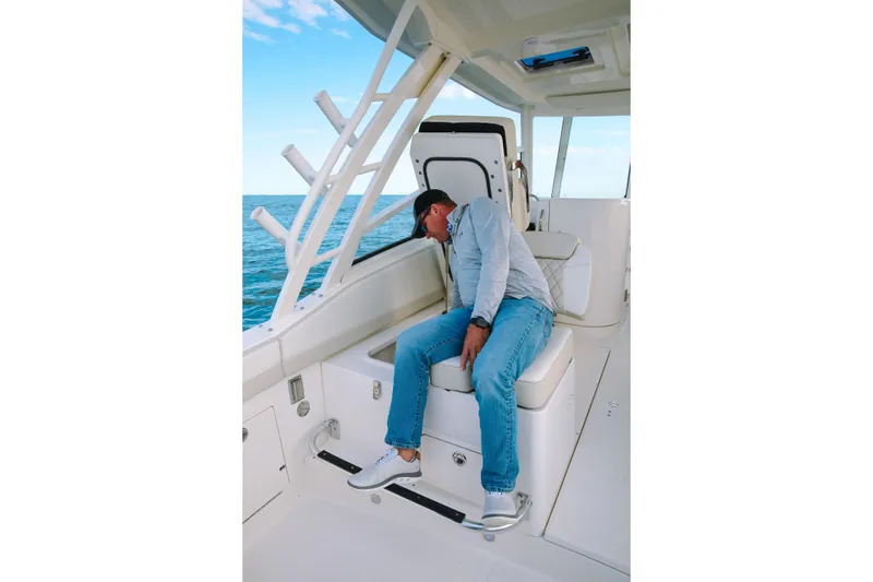 Slide: The Image of Man relaxing on 2026 World Cat 325DC boat, enjoying ocean view. - 11