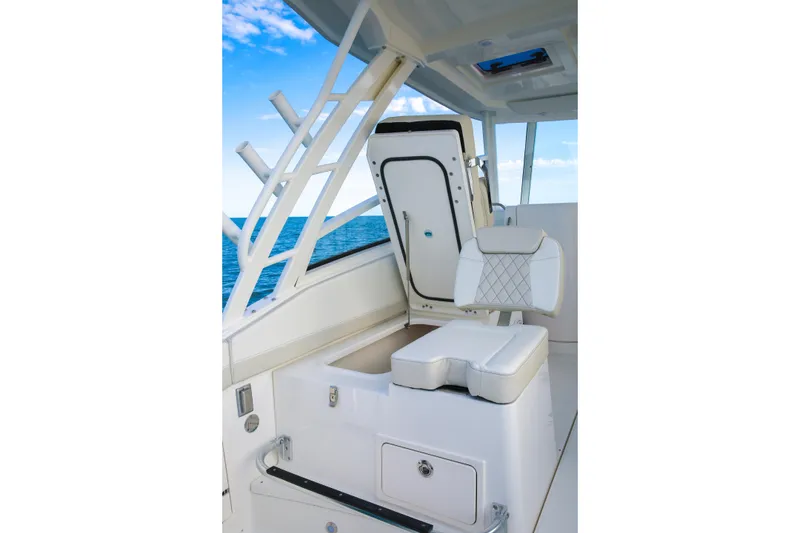 Slide: The Image of 2026 World Cat 325DC boat interior with white seating and ocean view. - 12