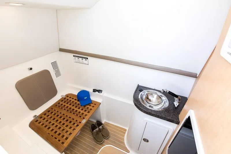 Slide: The Image of 2026 World Cat 325DC interior cabin with sink, wooden bench, and accessories. - 13