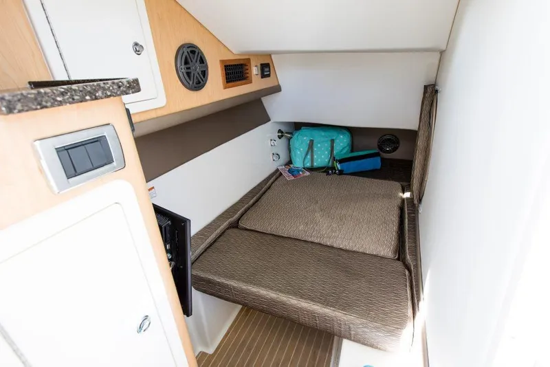 Slide: The Image of 2026 World Cat 325DC cabin interior with cozy bed and storage space. - 16