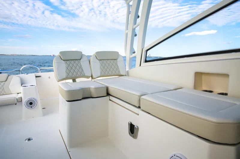 Slide: The Image of 2026 World Cat 325DC boat interior with luxurious seating and ocean view. - 8