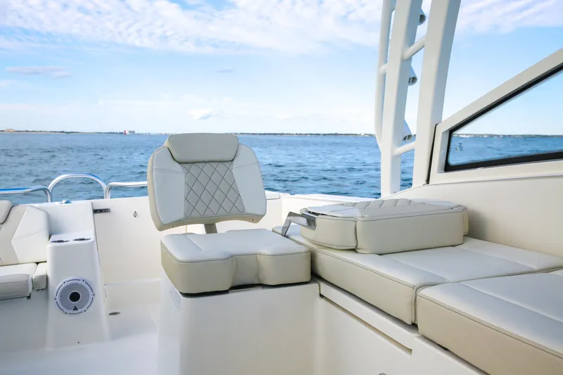 Slide: The Image of 2026 World Cat 325DC boat interior with luxurious seating and ocean view. - 9