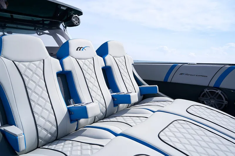 Slide: The Image of Luxurious seating on 2020 Midnight Express 43' Open boat with blue accents. - 10