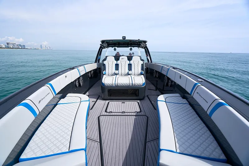 Slide: The Image of 2020 Midnight Express 43' Open boat with luxurious seating on calm ocean waters. - 11