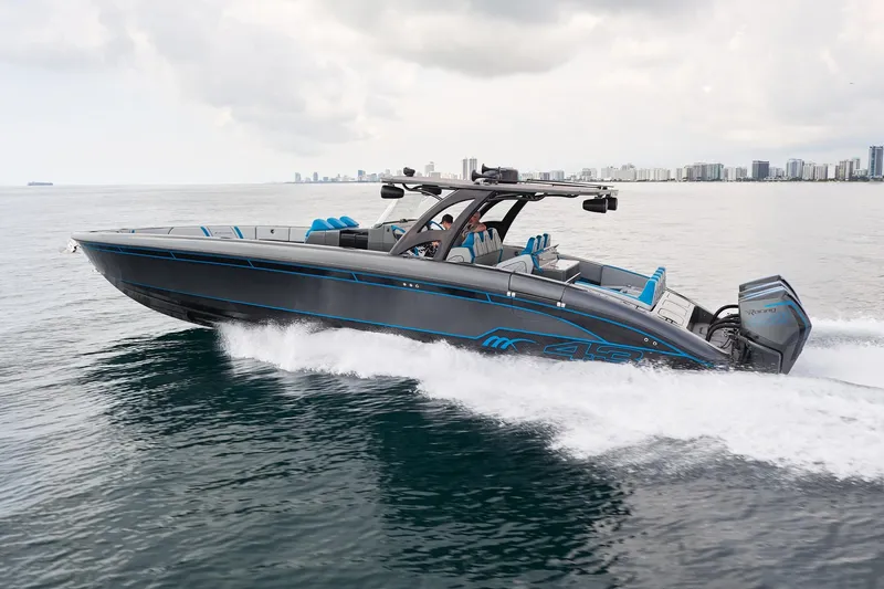 Slide: The Image of 2020 Midnight Express 43' Open boat cruising on water, city skyline in background. - 3