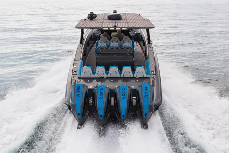 Slide: The Image of 2020 Midnight Express 43' Open boat with four powerful 450R engines cruising on water. - 4