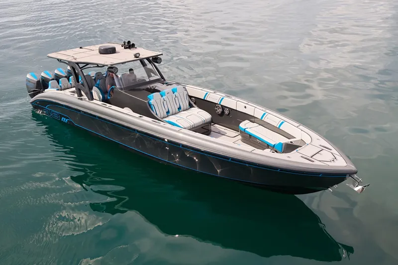 Slide: The Image of 2020 Midnight Express 43' Open boat on calm water, featuring sleek design and multiple engines. - 5