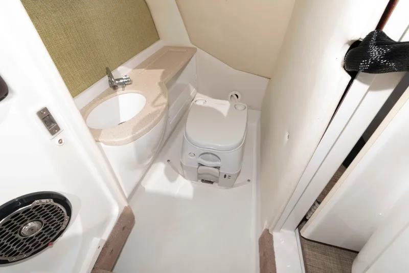 Slide: The Image of 2013 Cobalt A28 boat bathroom with sink and toilet, compact and modern design. - 14