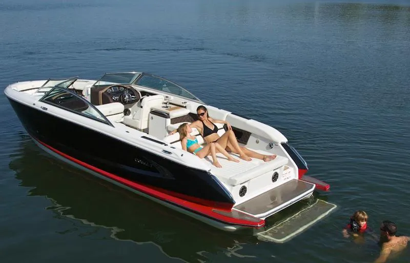 Slide: The Image of 2013 Cobalt A28 boat docked, featuring spacious seating and sleek design. - 2