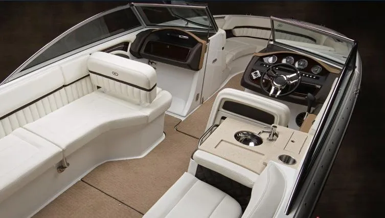 Slide: The Image of 2013 Cobalt A28 boat cockpit with leather seat, steering wheel, and control panel. - 5