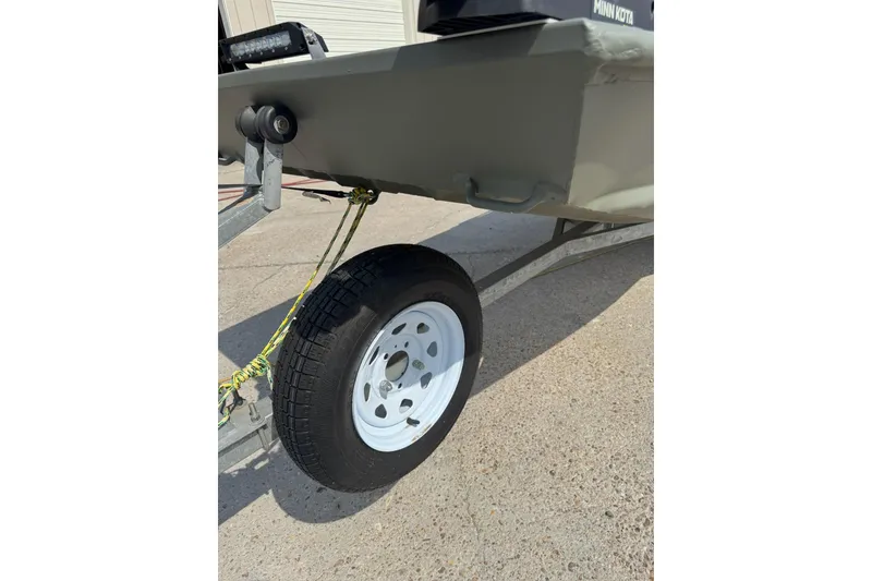 Slide: The Image of 2021 Weldcraft 15 boat trailer wheel on concrete surface. - 10