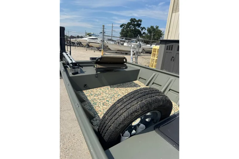 Slide: The Image of 2021 Weldcraft 15 boat interior with spare tire and textured flooring. - 11