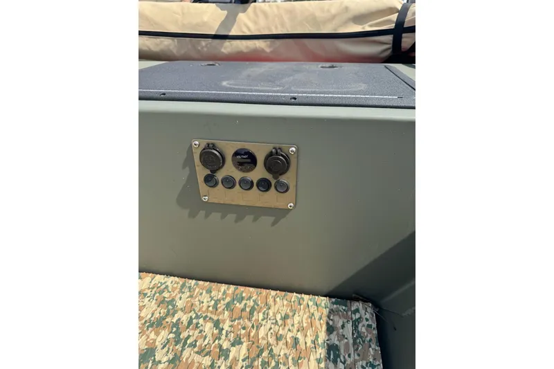 Slide: The Image of Control panel on a 2021 Weldcraft 15 boat, featuring multiple switches and a voltmeter. - 14