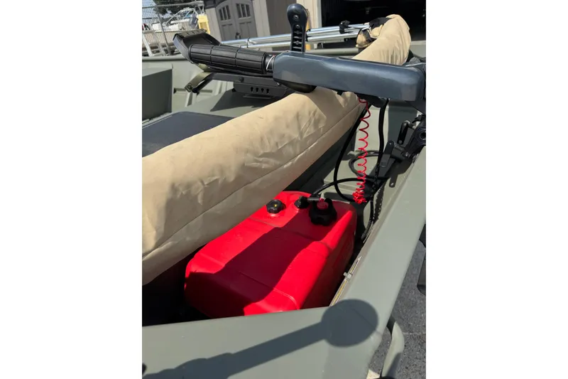 Slide: The Image of 2021 Weldcraft 15 boat interior with red fuel tank and steering controls. - 15